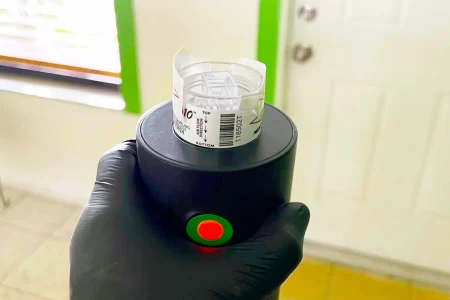 Device in hand with label